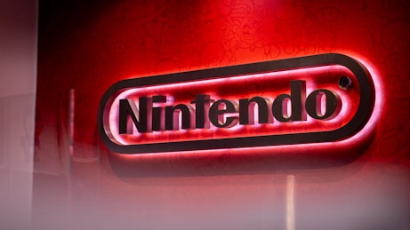 a nintendo logo lit up on a red wall