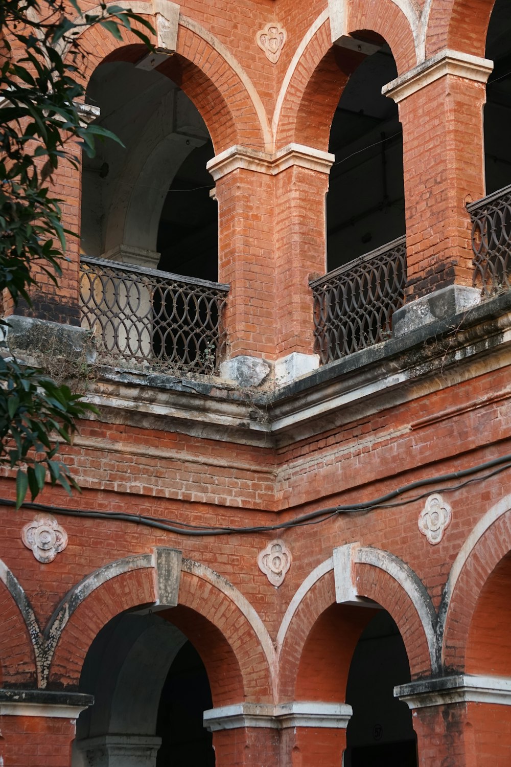 a building with arches and a clock on the side of it