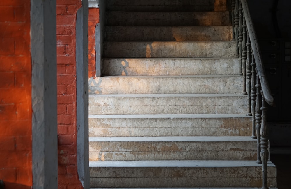 a set of stairs leading up to a brick wall