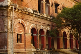an old brick building with arches and arches