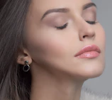 Bridal makeup session showcasing flawless, glowing skin and soft pink tones.