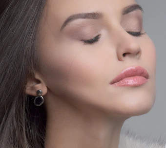 Close-up of a radiant bride with flawless bridal makeup and soft glowing skin.