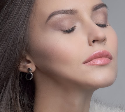 Elegant close-up of a bride's flawless makeup highlighting soft blush tones.