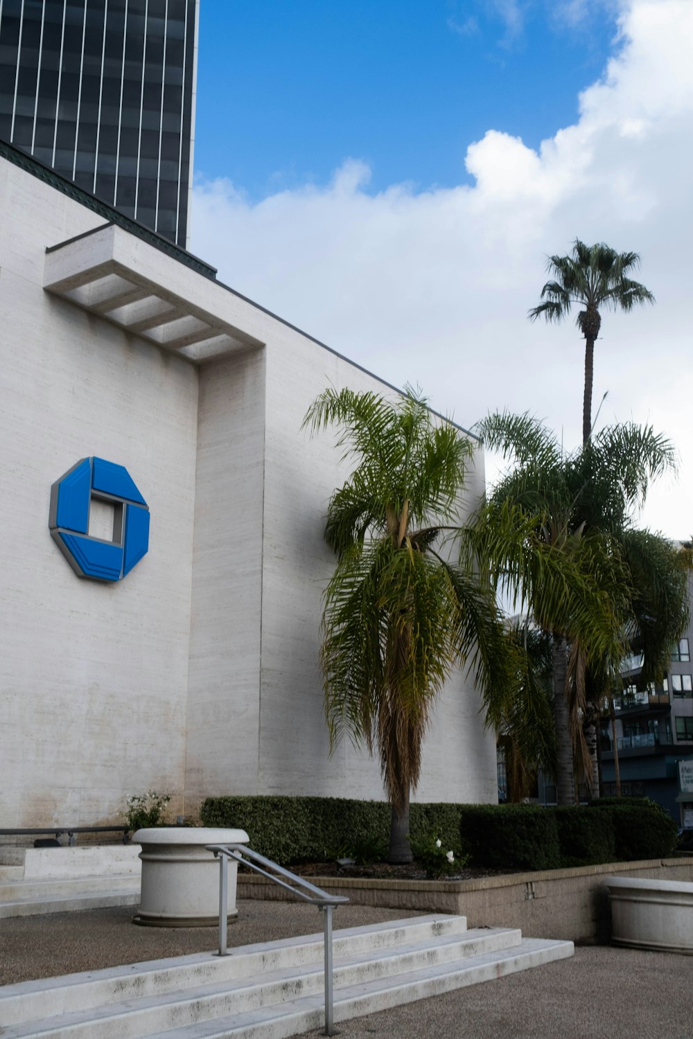 a white building with a blue sign on the side of it