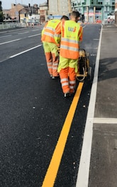 a couple of men that are standing in the street