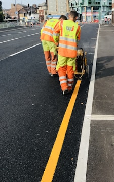 a couple of men that are standing in the street