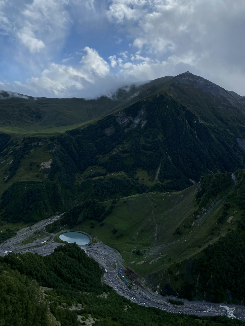 a view of a mountain with a lake in the middle of it