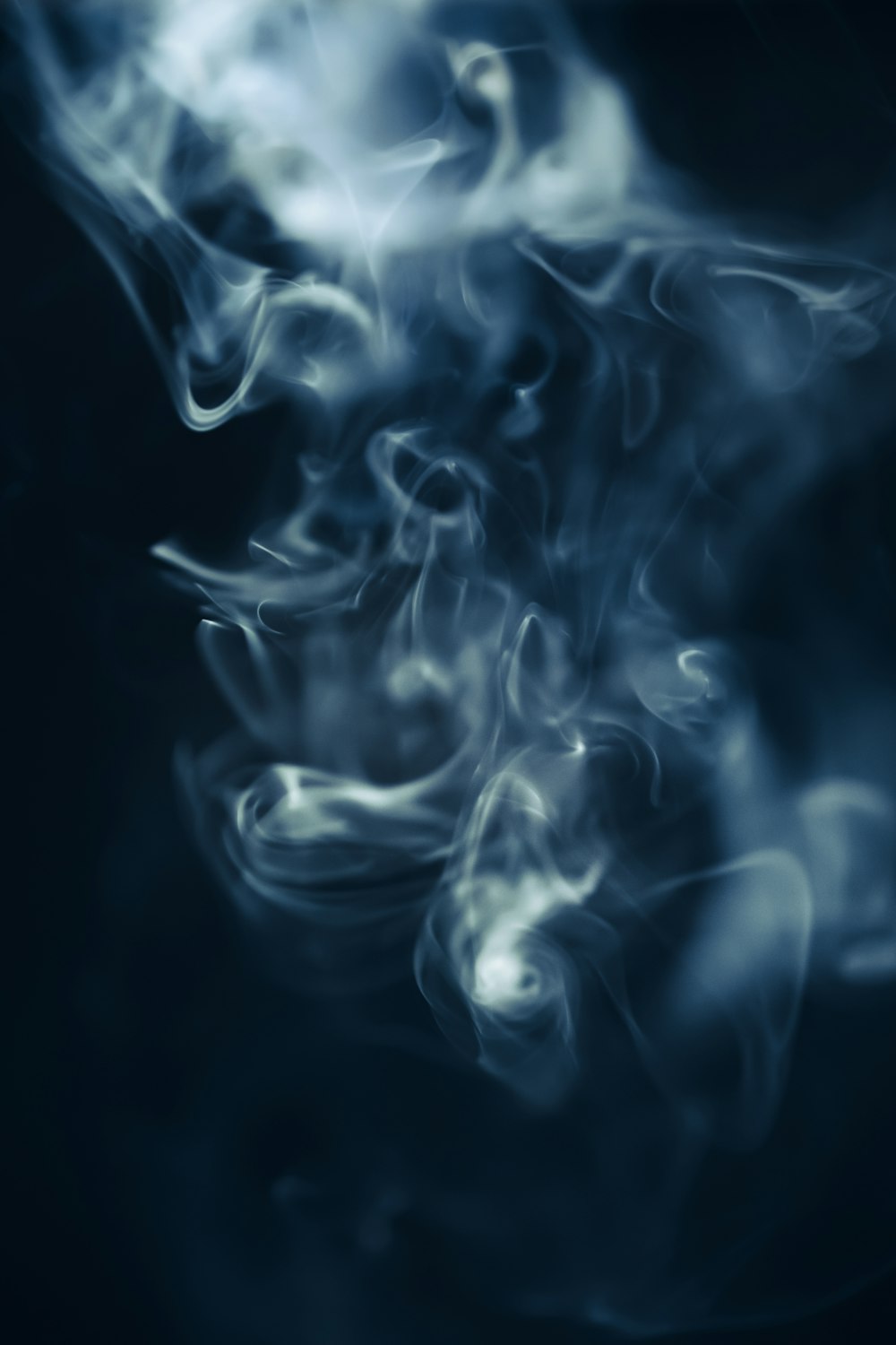 a blue background with white smoke coming out of it