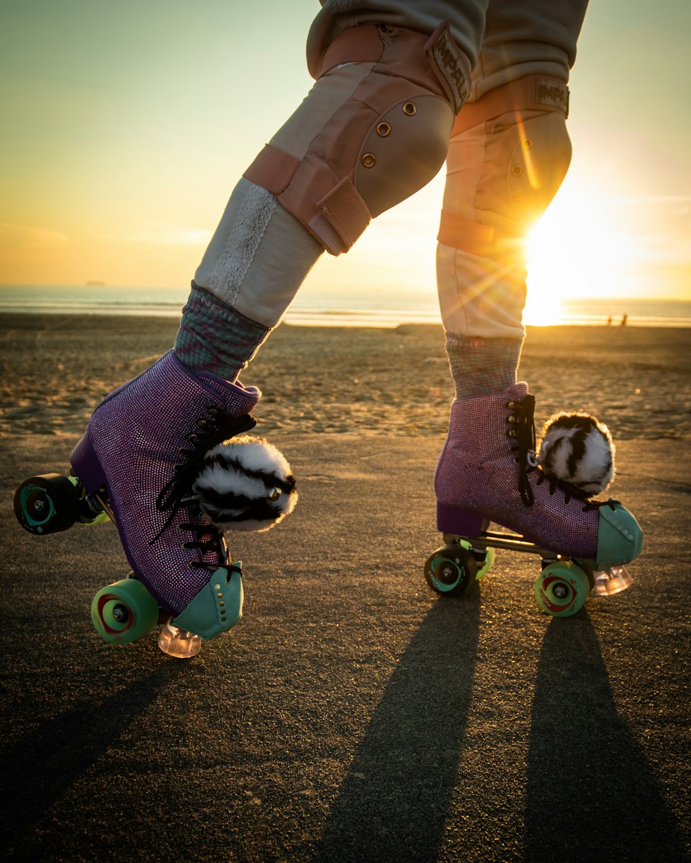 a person riding a skateboard on a beach