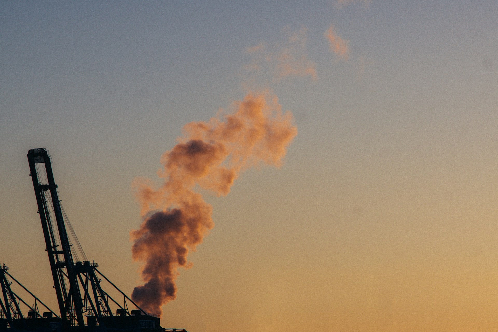 a smokestack emits from the top of a building
