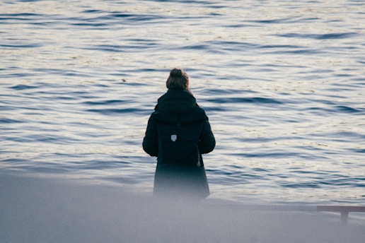 a person standing in front of a body of water
