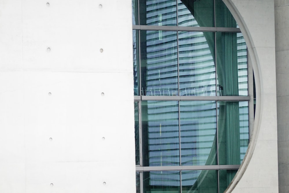 a circular window with a curtain and a clock