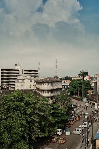 a view of a city street with cars and buses