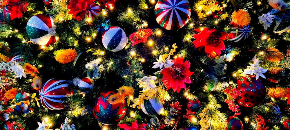 a christmas tree is decorated with colorful ornaments