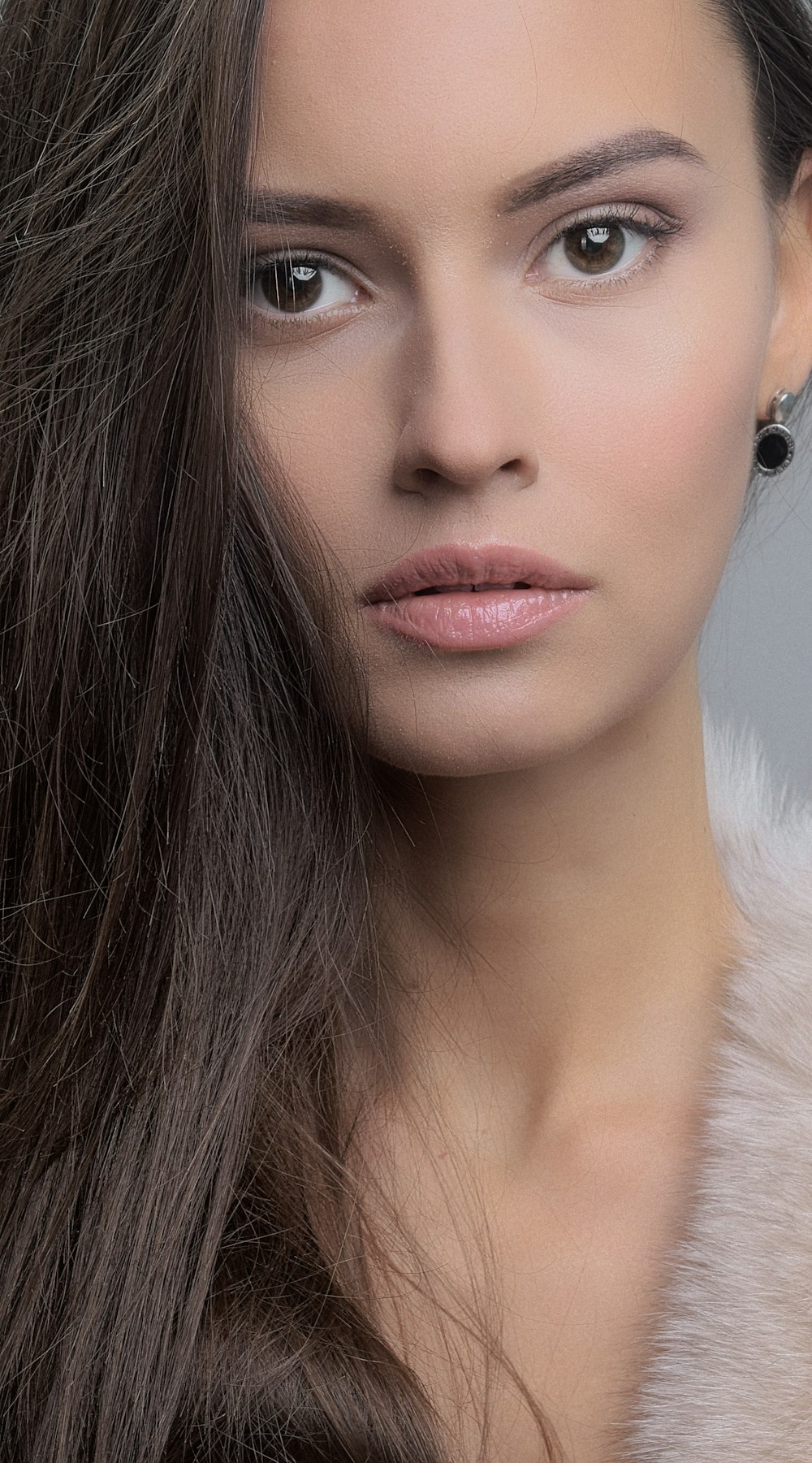 a woman with long hair and a fur collar