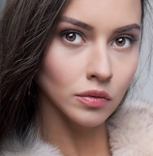 a woman wearing a fur collar and a fur coat