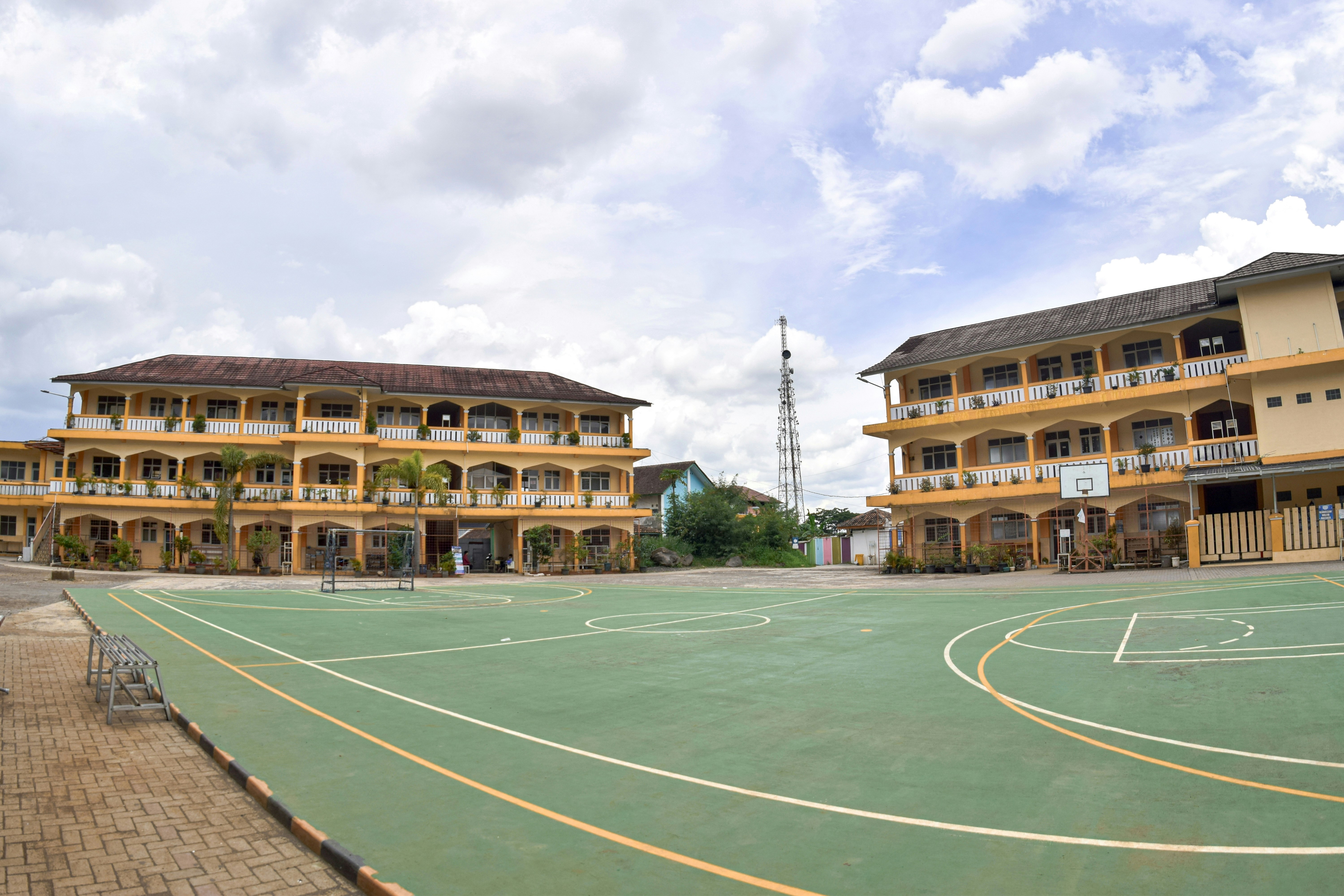 a basketball court in front of a large building