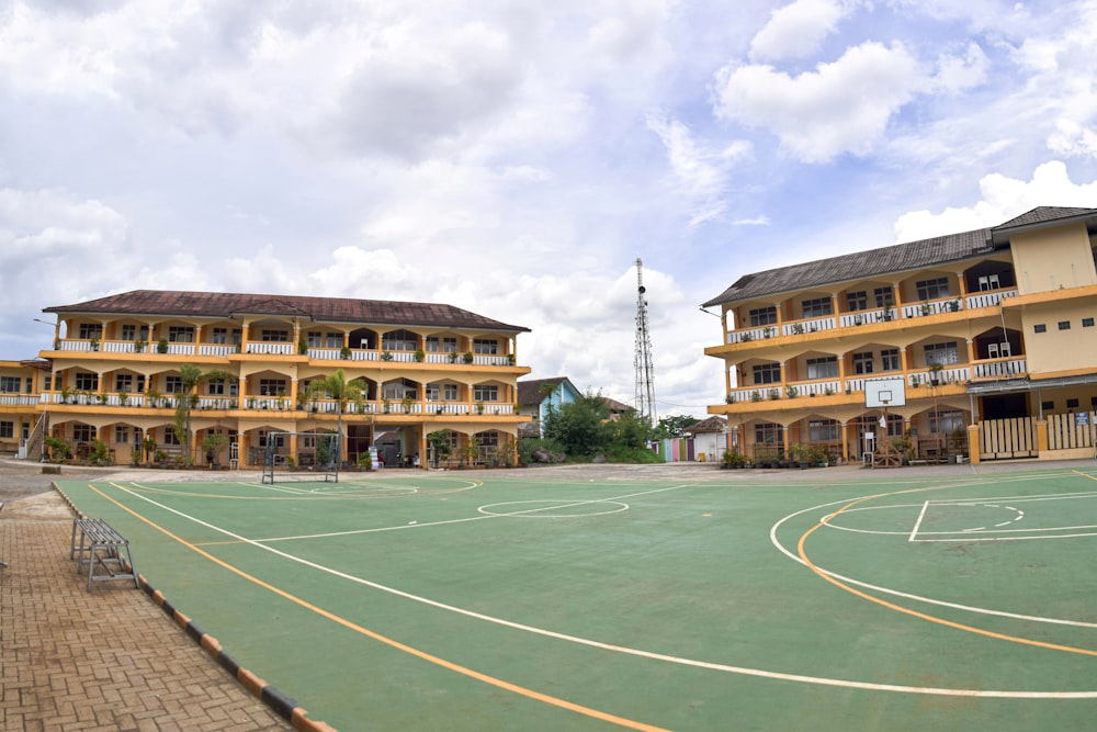 a basketball court in front of a large building