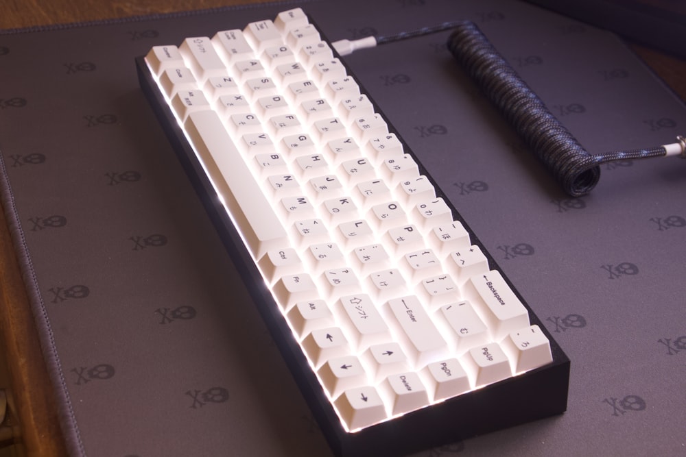 a white keyboard sitting on top of a table