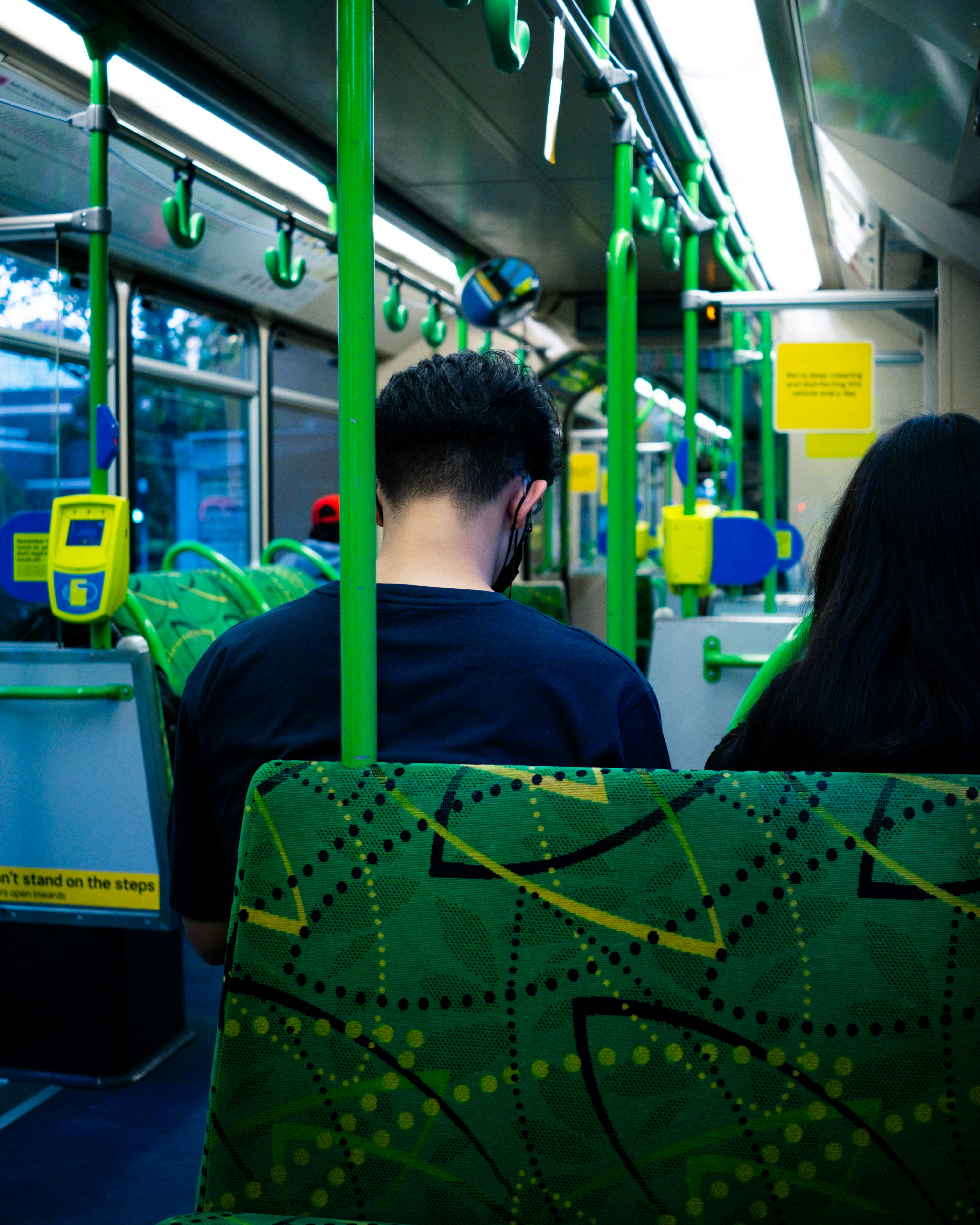 a man and a woman sitting on a bus