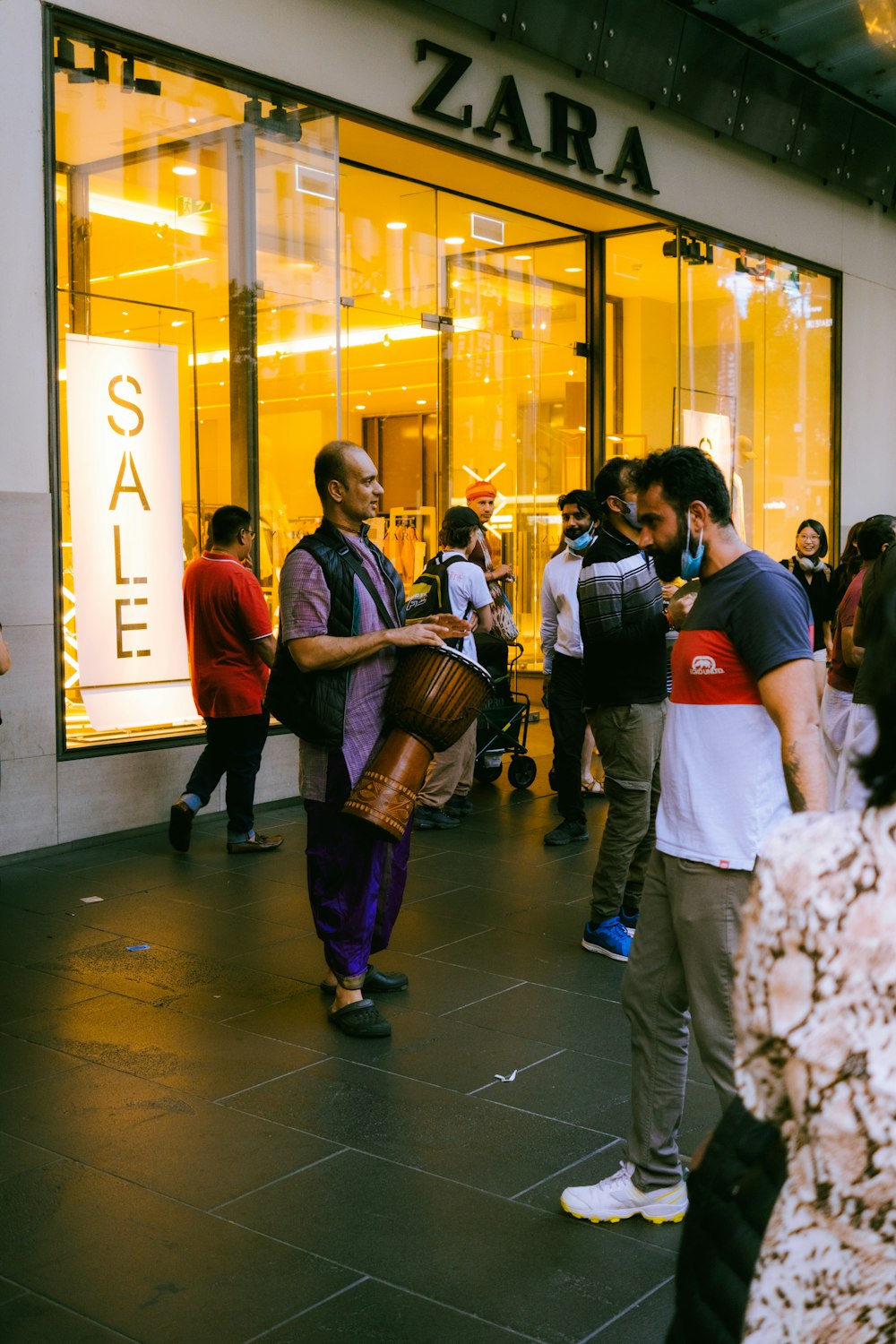 a group of people standing outside of a store