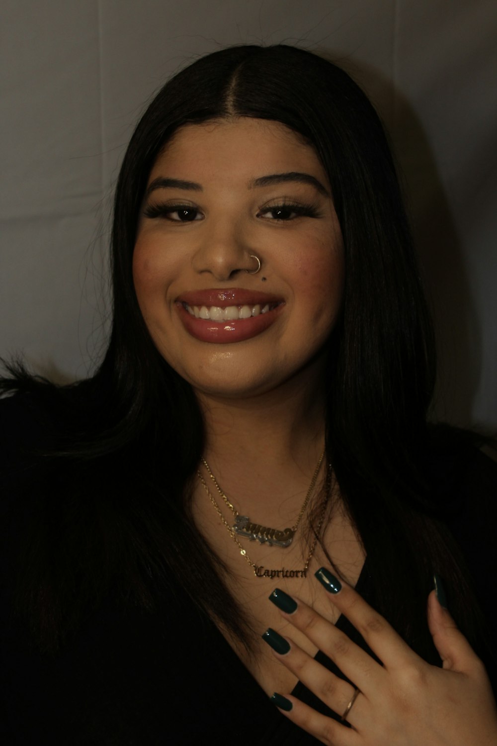 a woman with a nose ring smiling at the camera