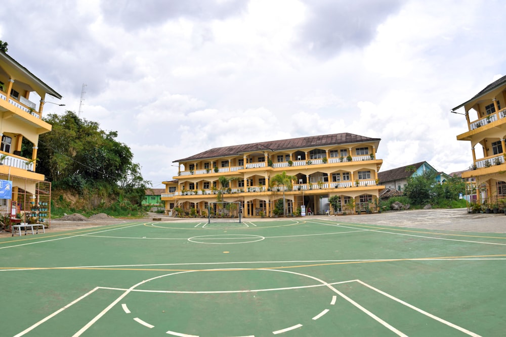 a basketball court in front of a large building