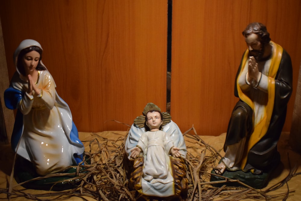a nativity scene of three figurines of jesus and mary