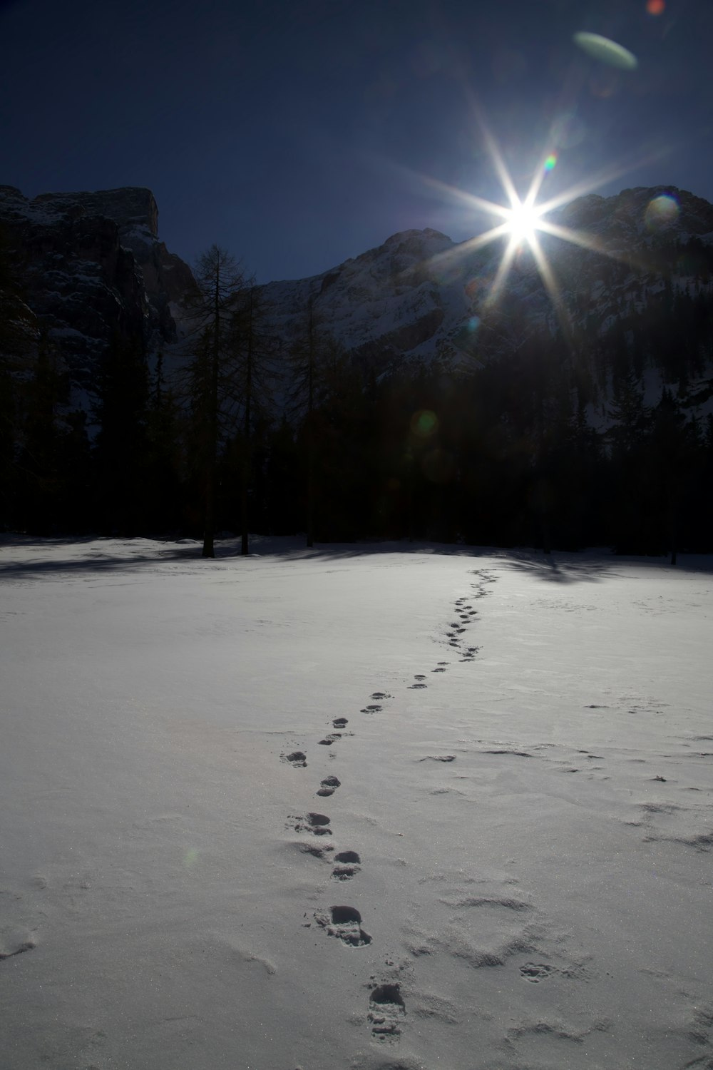 a person walking across a snow covered field