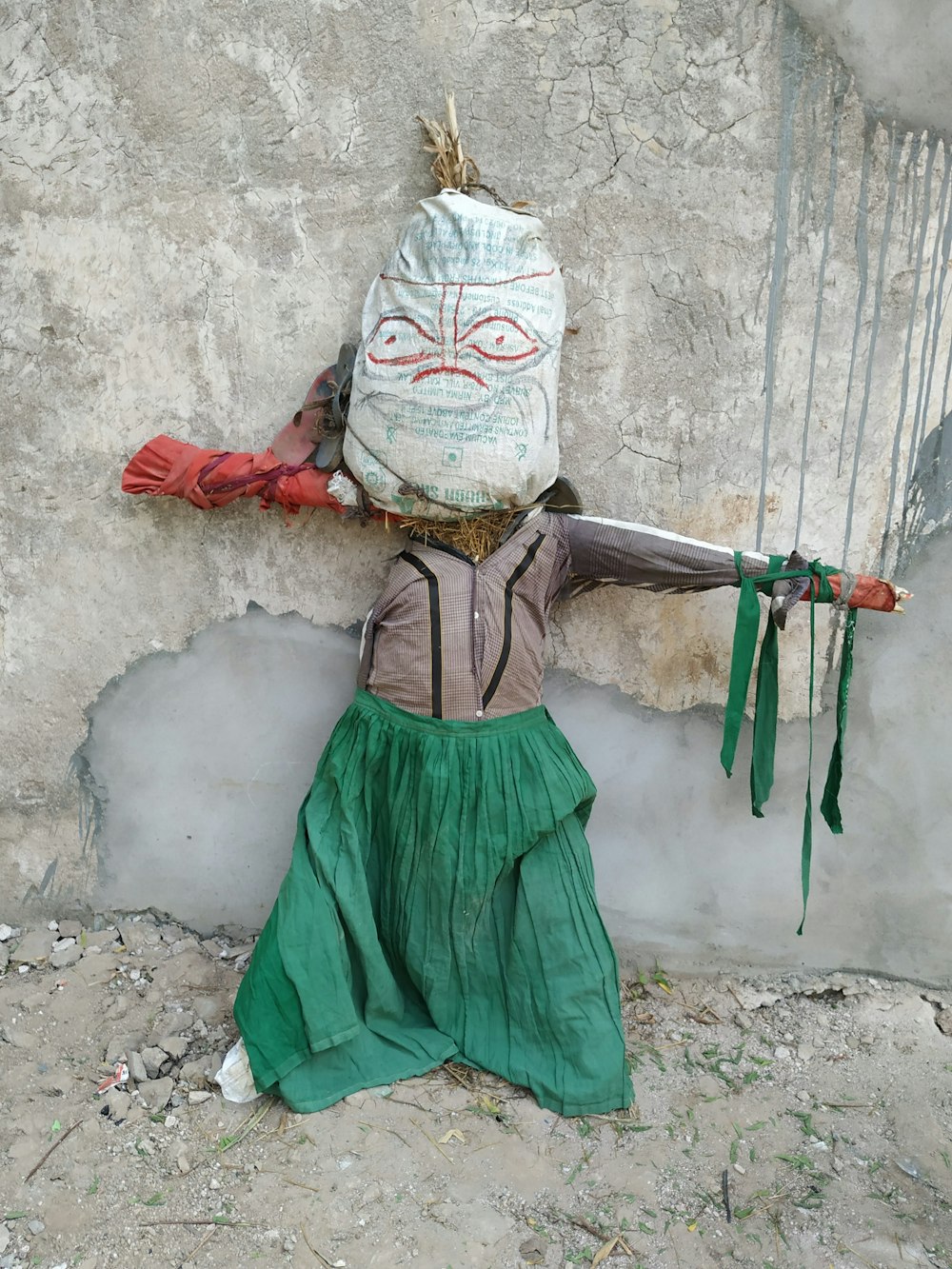 a scarecrow with a bag on his head