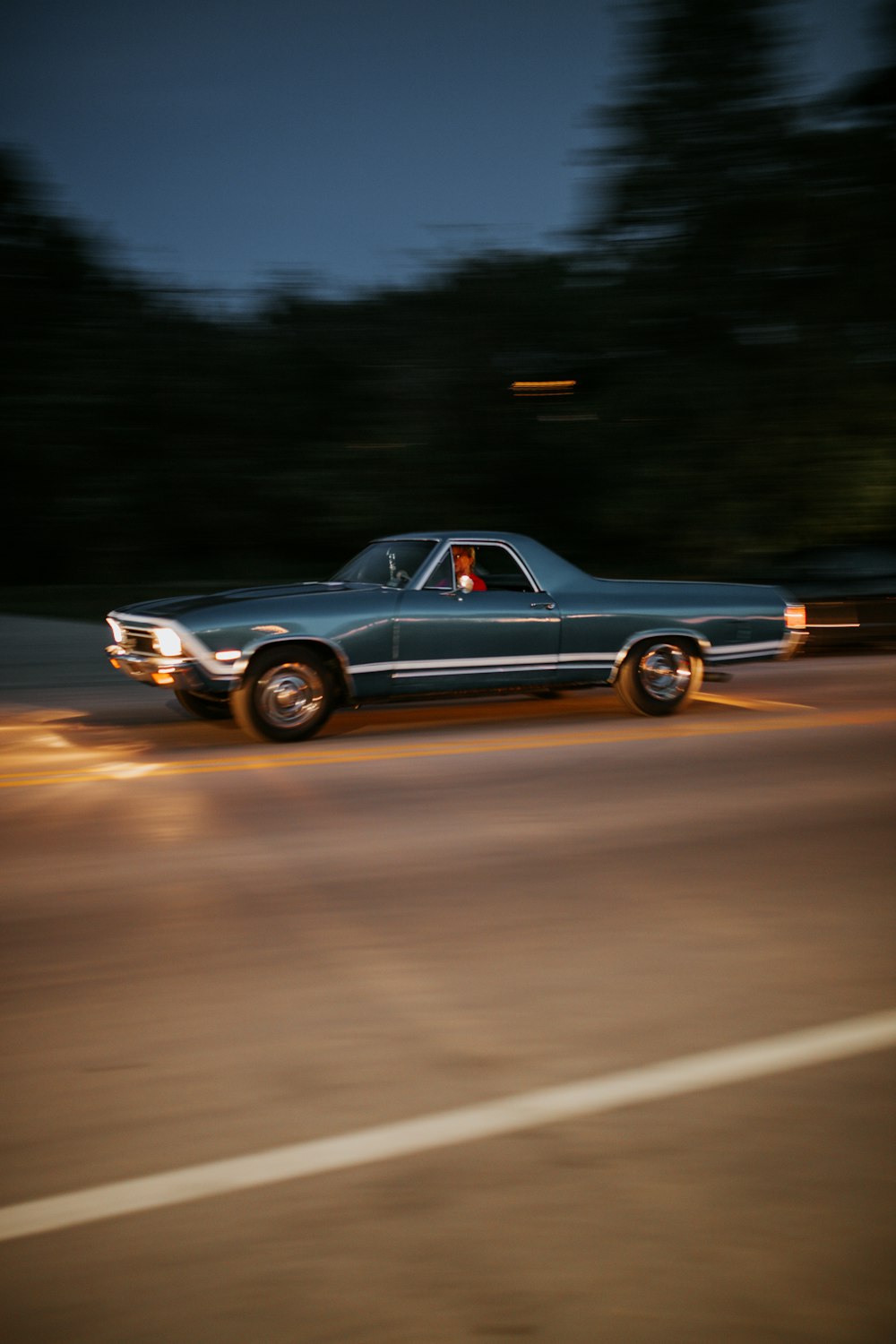 a car driving down a street at night