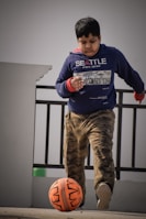 A boy playing soccer in comfortable solelegend activewear on a sunny day.