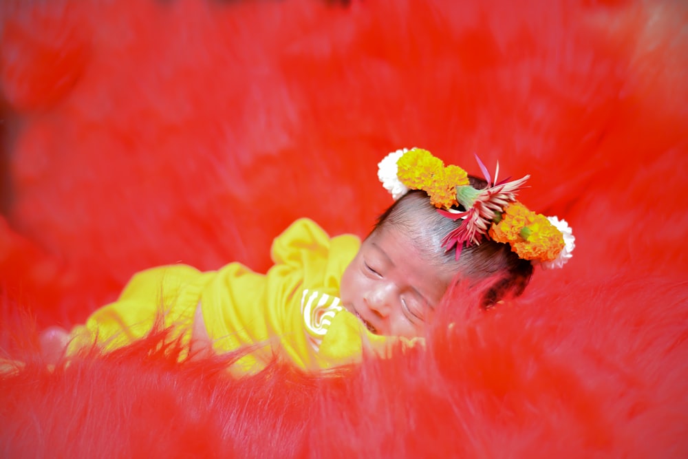 a baby with a flower in her hair