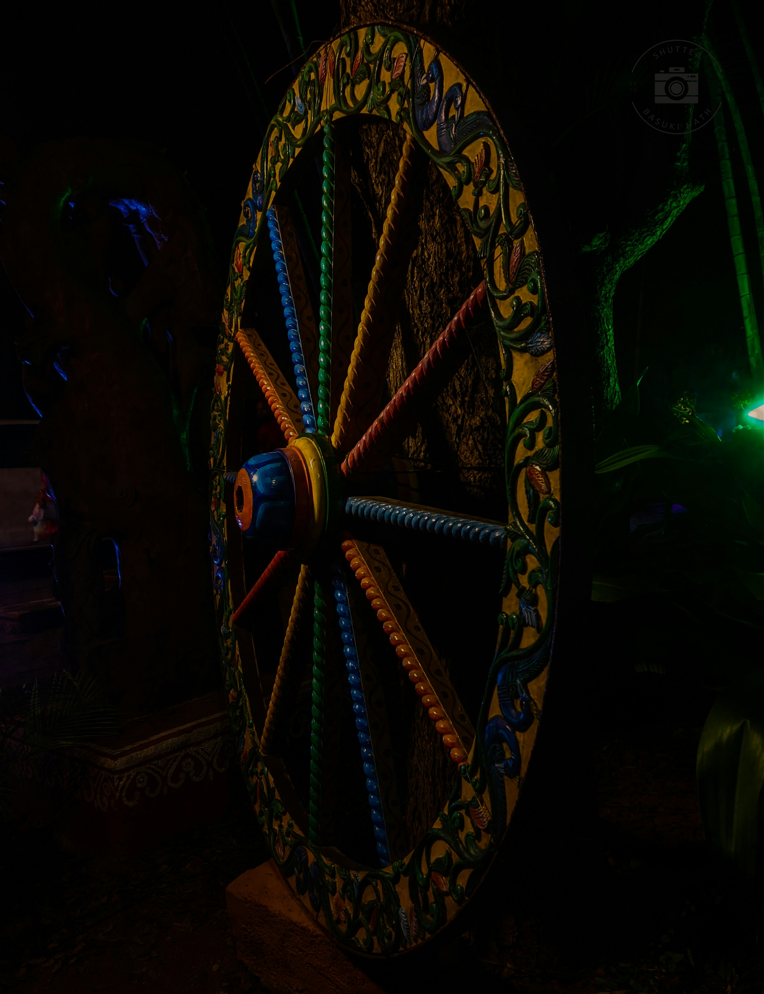 A large, ornate, spinning wheel with celestial symbols, glowing with magical energy.
