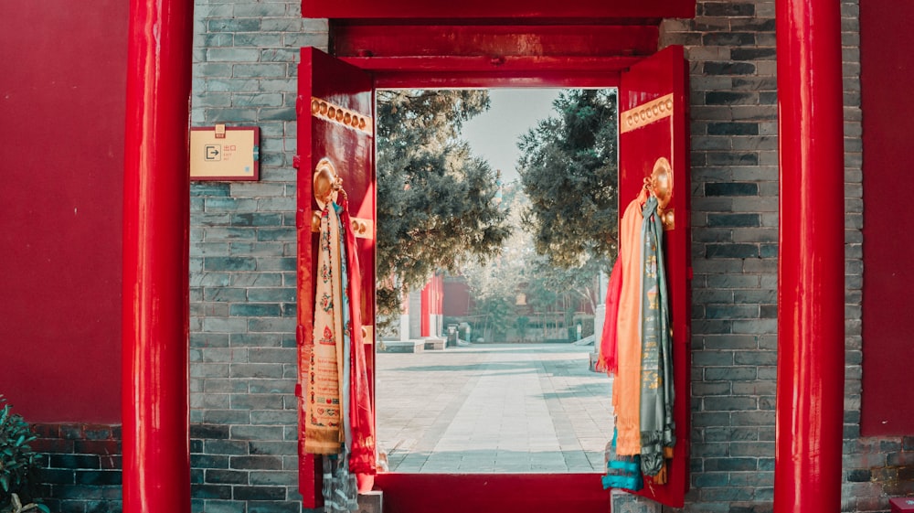 a red doorway with a red brick wall