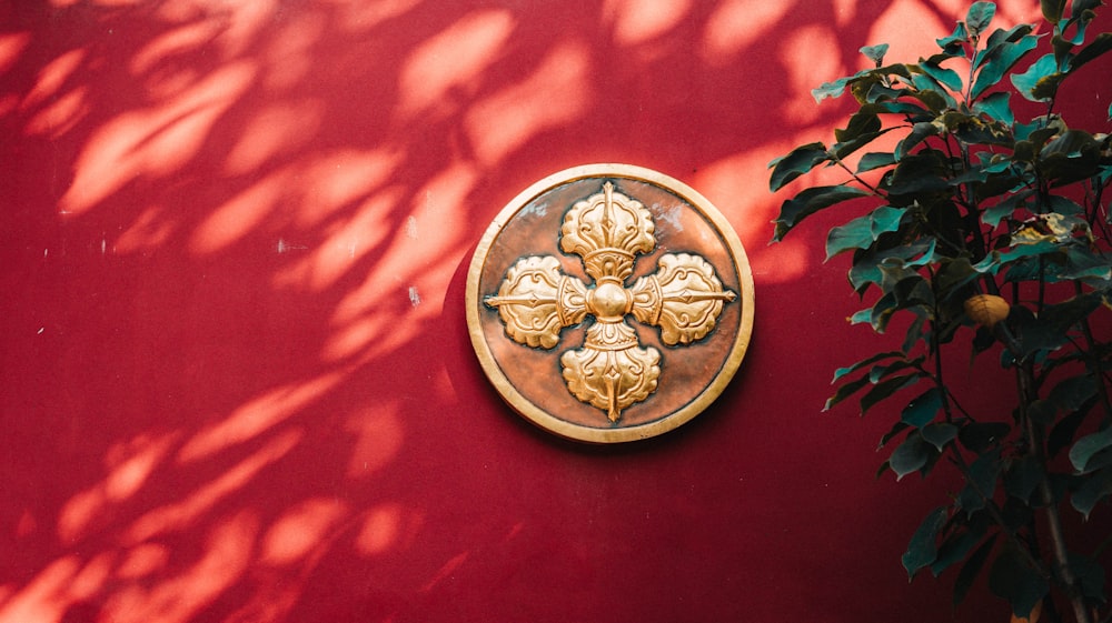 a red wall with a gold plaque on it