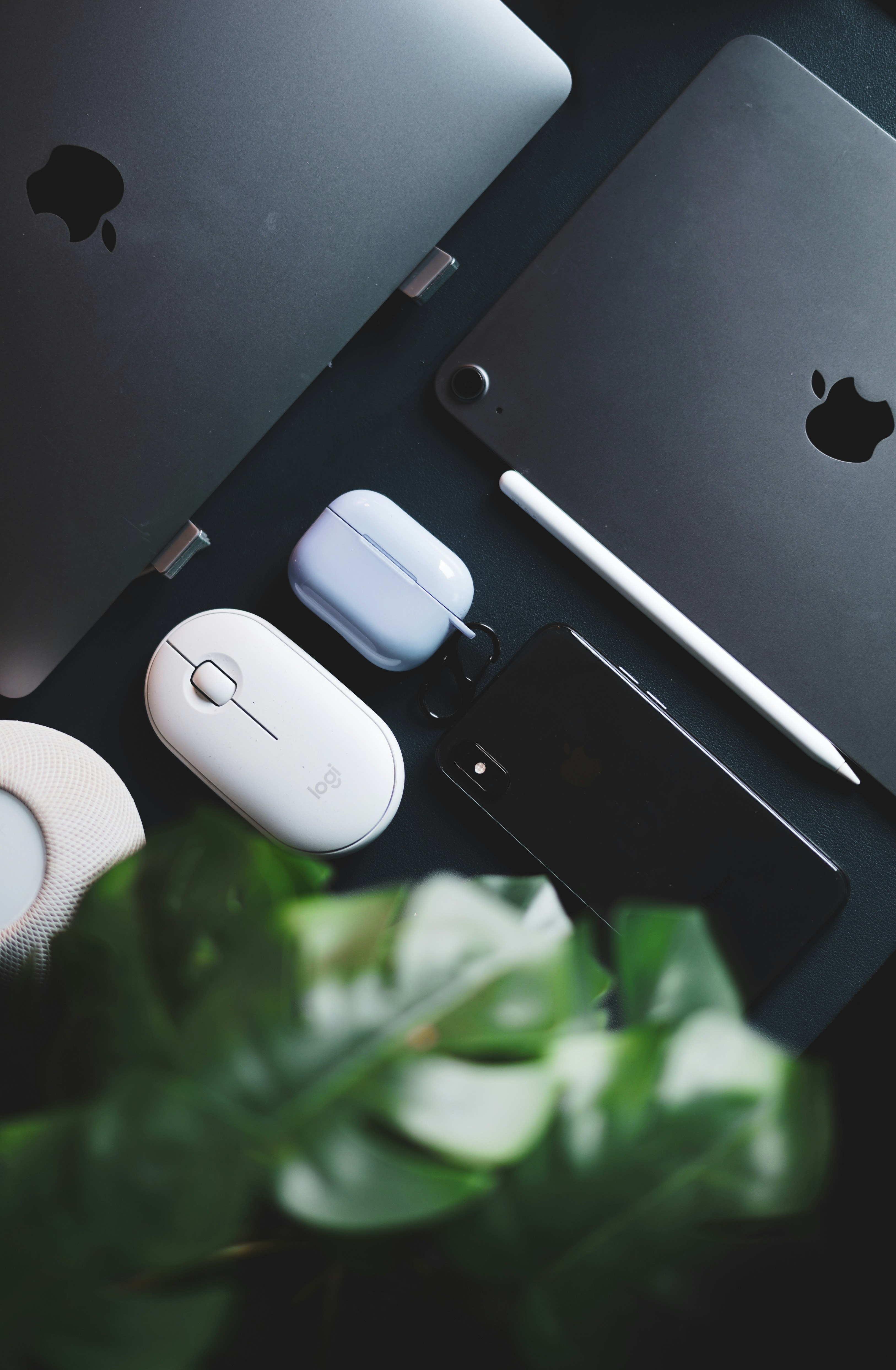 a table topped with a laptop computer next to a mouse