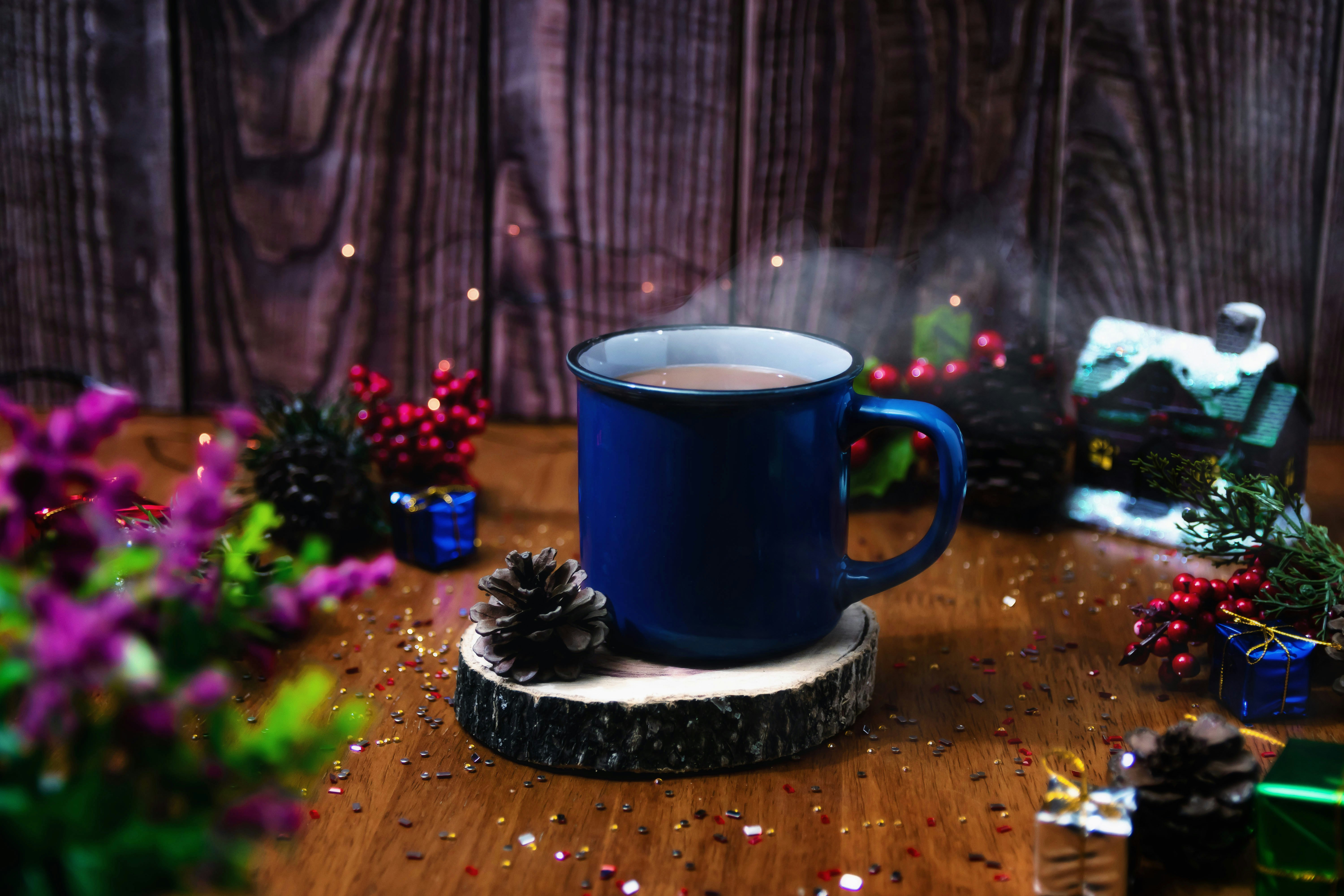 a cup of coffee sitting on top of a wooden table