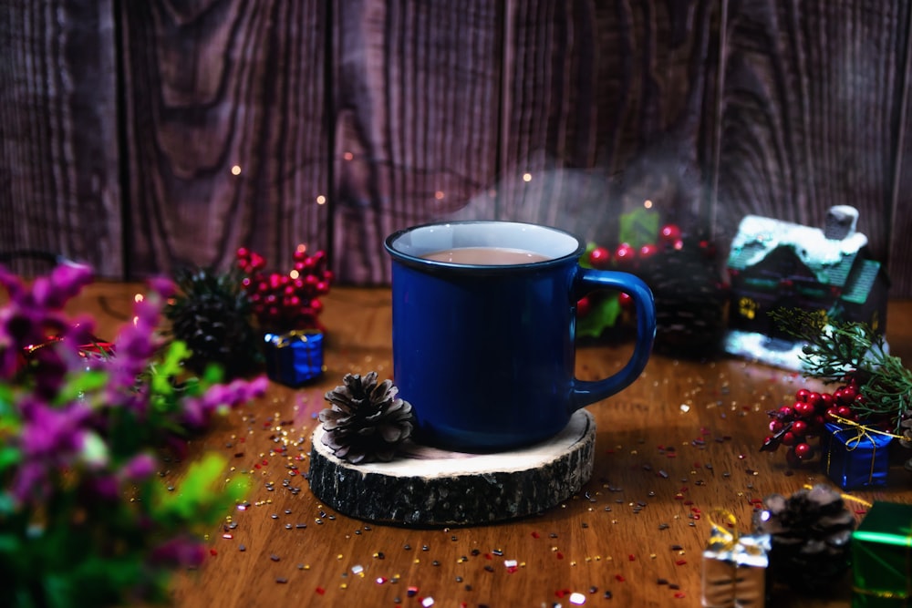 a cup of coffee sitting on top of a wooden table