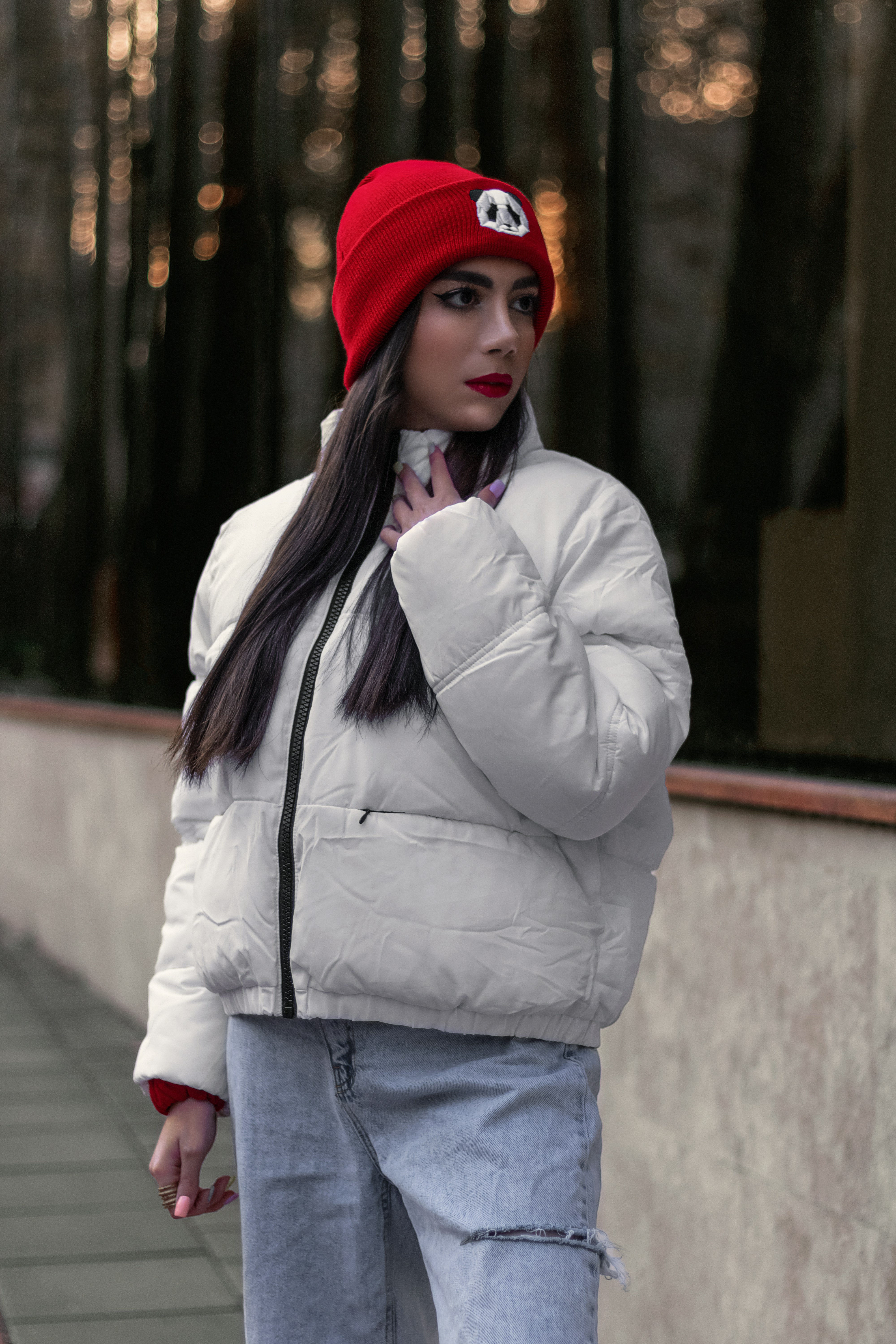 a woman with long hair wearing a red beanie