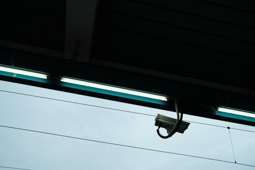 a security camera hanging from the side of a building
