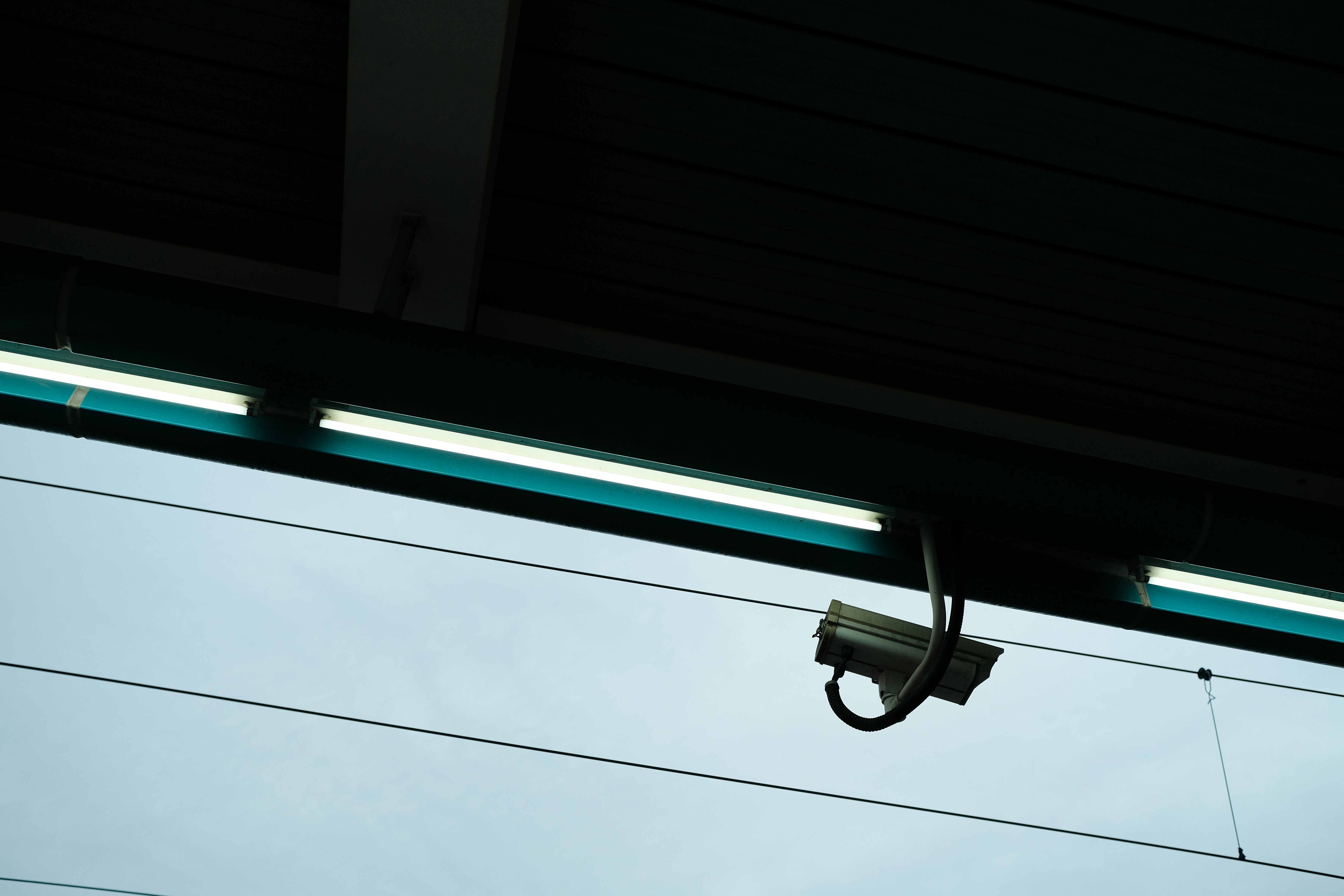a security camera hanging from the side of a building