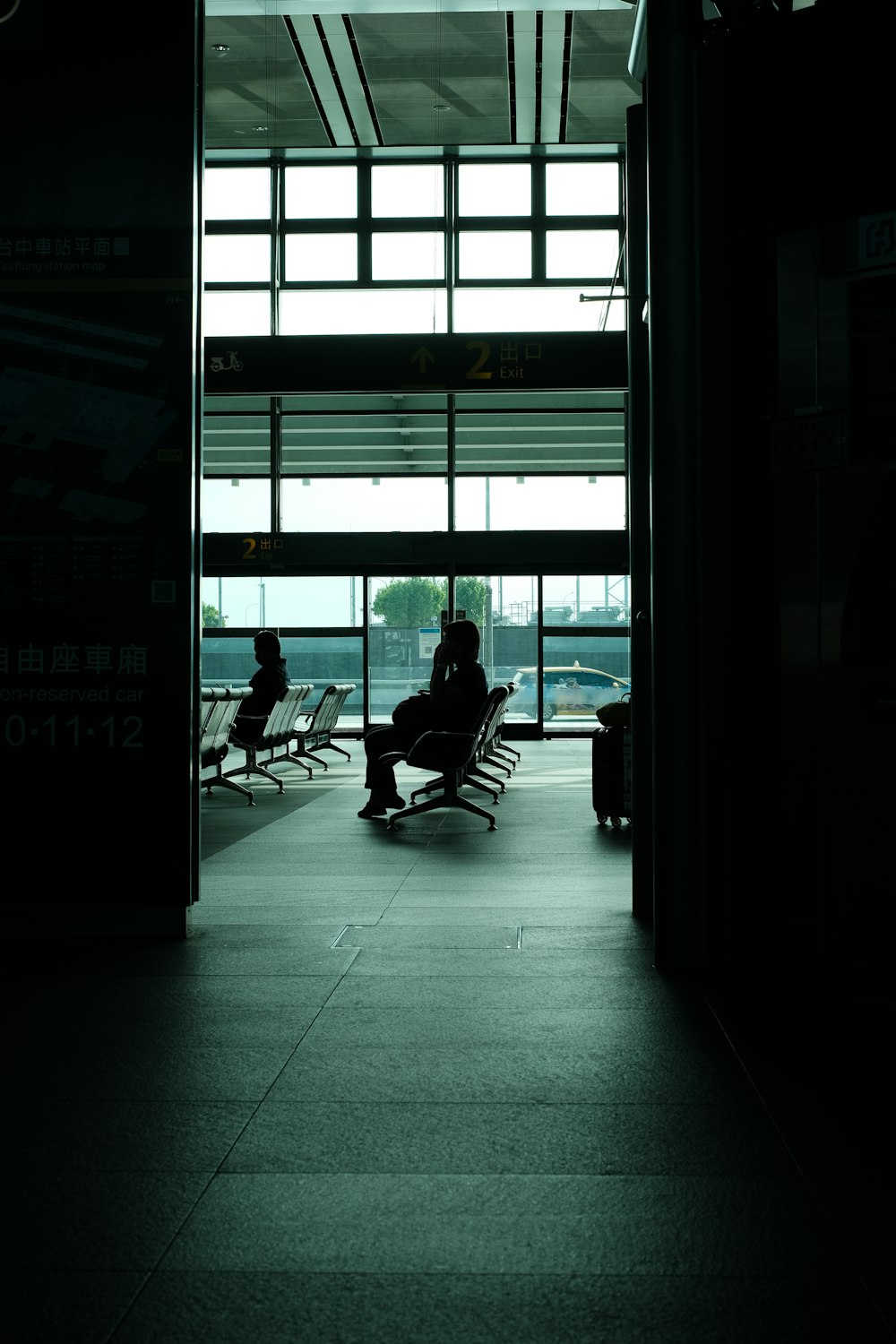 a person sitting in a chair at an airport