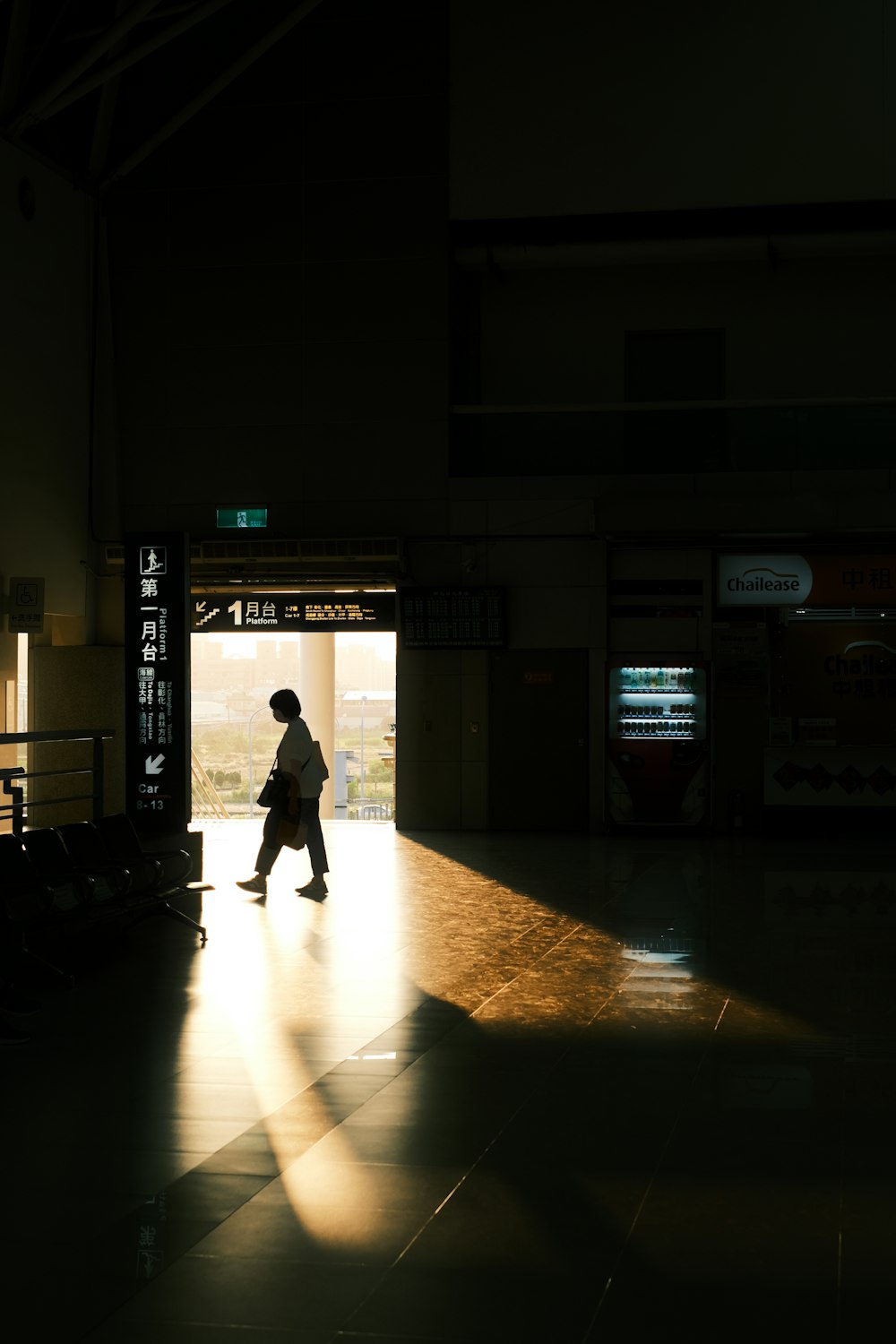 a person walking into a train station at night
