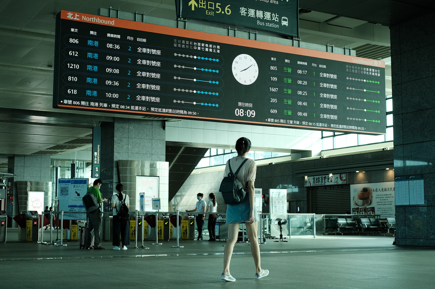 Traveler moving through a modern airport terminal with luggage