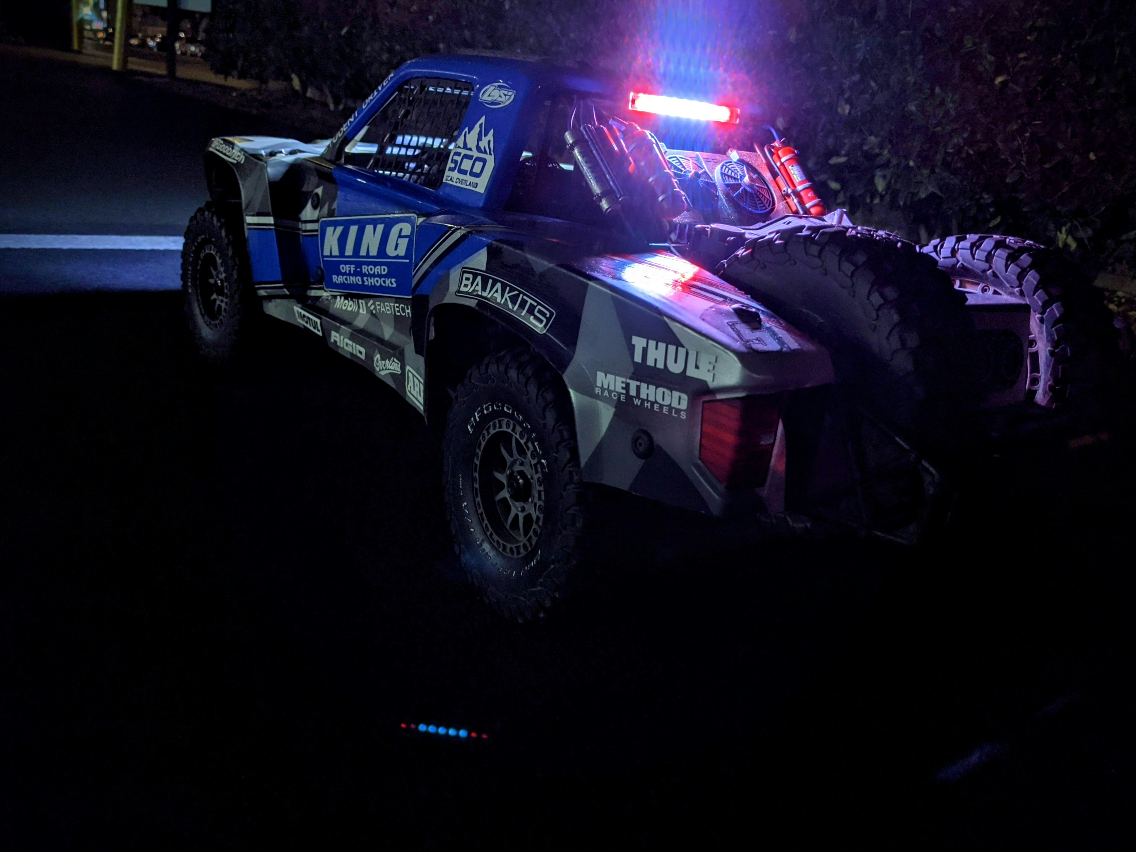 a police truck with its lights on in the dark