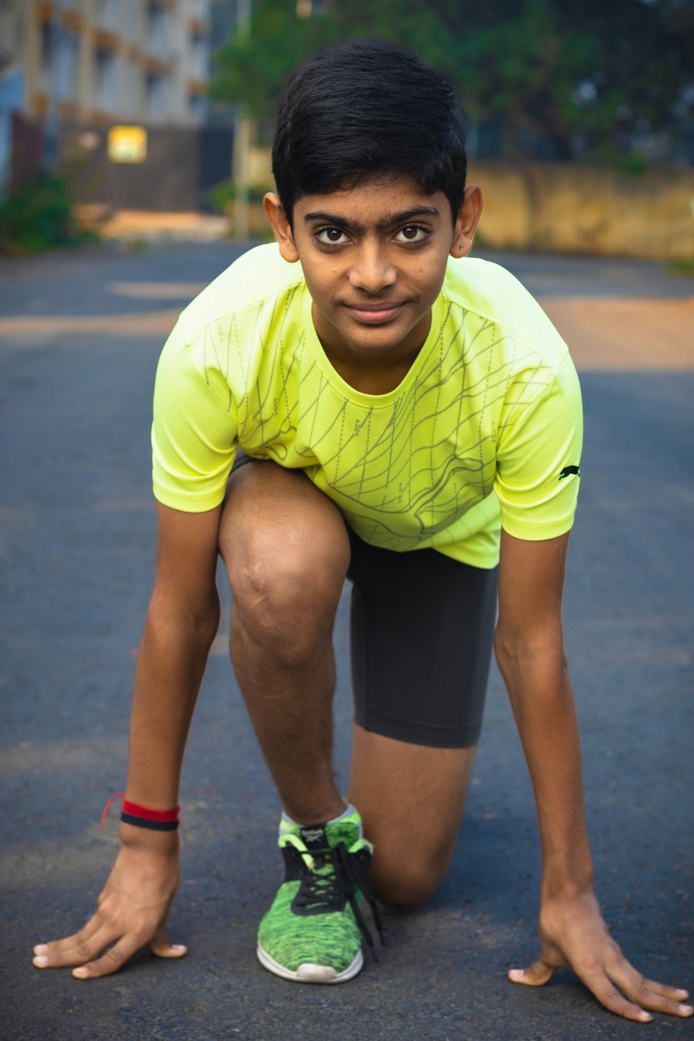 a man in a yellow shirt crouching down