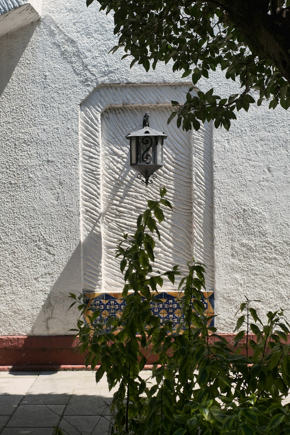 a white building with a light on the side of it