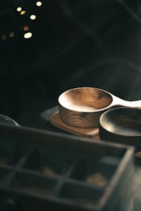 Close-up of elegant boleiras displayed on a rustic wooden table with soft natural light.