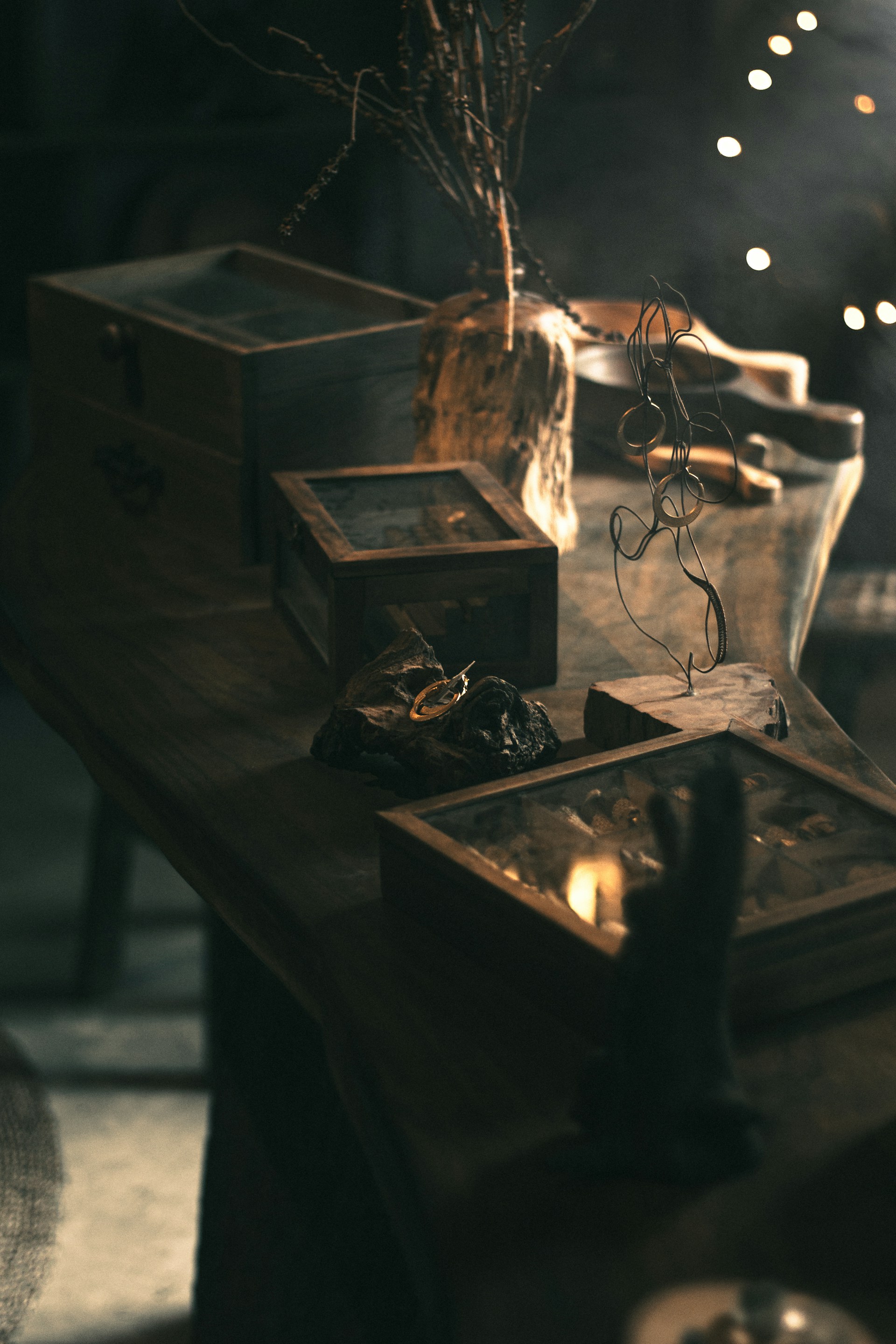 a wooden table topped with boxes and a vase filled with flowers